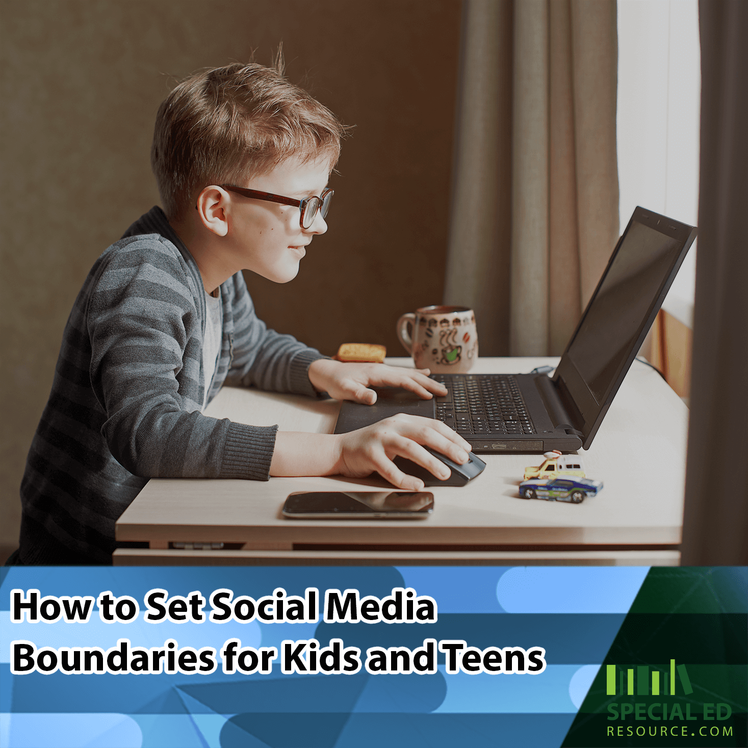 A young boy with glasses focused on using a laptop at a desk, with a mug and smartphone nearby, using the social media boundaries for kids his parents established from the tips in this blog post by https://ser-testing.youare.ninja/